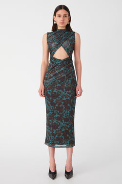 Girl wearing Printed mesh sleeveless midi dress. Dress is a back and green abstract print with a triangle mid-section cutout just below the bust.