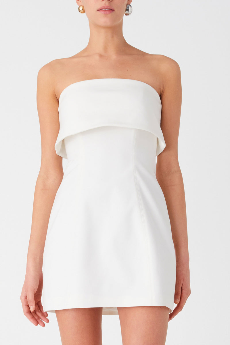 Ivory strapless mini dress with bandeau fold over detail. Dress is A-line and worn with black heels.