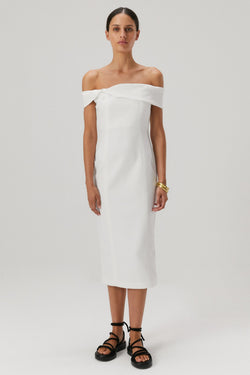 Brown hair girl wearing an off the shoulder bonded crepe midi dress in an ivory colour. 