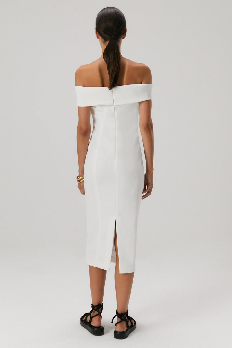 Brown hair girl wearing an off the shoulder bonded crepe midi dress in an ivory colour.